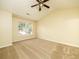 Spacious bedroom featuring vaulted ceilings, a ceiling fan, carpeted floors and a large window at 8679 Grassy Oak Trl, North Charleston, SC 29420