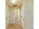 Hallway with wood floors featuring a view into a half bathroom at 8679 Grassy Oak Trl, North Charleston, SC 29420