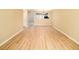 Open living room with hardwood floors and neutral paint, adjacent to the kitchen at 8679 Grassy Oak Trl, North Charleston, SC 29420