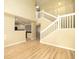 View of the living room featuring stairs with white banisters and wood flooring at 8679 Grassy Oak Trl, North Charleston, SC 29420
