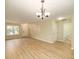 Spacious living room with wood floors, a chandelier, and multiple entrances at 8679 Grassy Oak Trl, North Charleston, SC 29420