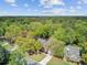 Wide aerial view of a tree-lined neighborhood featuring a well-maintained home with mature landscaping at 8781 Laurel Grove Ln, North Charleston, SC 29420