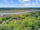 Scenic aerial view of homes nestled among lush trees near a tranquil river or marshland at 8781 Laurel Grove Ln, North Charleston, SC 29420
