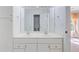 Bright bathroom with a double sink vanity, white cabinets, and a large mirror at 8781 Laurel Grove Ln, North Charleston, SC 29420