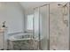 Bathroom with a large marble soaking tub and glass block window for privacy at 8781 Laurel Grove Ln, North Charleston, SC 29420