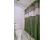 Cozy bathroom featuring a toilet and a shower with a stylish striped curtain at 8781 Laurel Grove Ln, North Charleston, SC 29420