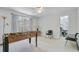 Versatile bonus room featuring a foosball table, neutral walls and adjoining room with skylight at 8781 Laurel Grove Ln, North Charleston, SC 29420