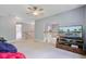 Bonus room with a ceiling fan, staircase and a large screen TV in the background at 8781 Laurel Grove Ln, North Charleston, SC 29420