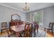 Spacious dining room with hardwood floors, large window, and a classic chandelier above a formal dining set at 8781 Laurel Grove Ln, North Charleston, SC 29420