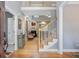 Elegant foyer showcasing hardwood floors, a staircase, and a glimpse into the cozy living room with a fireplace at 8781 Laurel Grove Ln, North Charleston, SC 29420