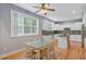 Bright kitchen featuring white cabinets, stainless steel appliances, and hardwood floors at 8781 Laurel Grove Ln, North Charleston, SC 29420