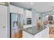 Open kitchen featuring stainless steel appliances, island, and view of the living area at 8781 Laurel Grove Ln, North Charleston, SC 29420