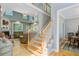 Foyer featuring hardwood stairs, living room view, and dining area at 8781 Laurel Grove Ln, North Charleston, SC 29420
