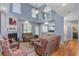 Cozy living room boasting high ceilings, a fireplace, hardwood floors, and comfortable seating at 8781 Laurel Grove Ln, North Charleston, SC 29420