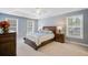Main bedroom with tray ceiling, neutral walls, and lots of natural light at 8781 Laurel Grove Ln, North Charleston, SC 29420