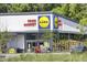 Modern retail exterior featuring a grocery store with a welcoming entrance and ample parking at 8781 Laurel Grove Ln, North Charleston, SC 29420