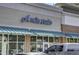 Retail building featuring large windows, awning, and inviting signage for commercial tenant at 8781 Laurel Grove Ln, North Charleston, SC 29420