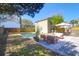 Landscaped backyard with a pool, patio seating, and mature trees for shade at 905 Simmons St, Mount Pleasant, SC 29464