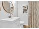 Clean bathroom featuring a modern vanity, toilet, mirror and artistic decor at 905 Simmons St, Mount Pleasant, SC 29464