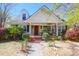 Charming home featuring a welcoming front porch and beautifully landscaped front yard with mature trees and shrubs at 905 Simmons St, Mount Pleasant, SC 29464