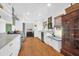 Well-lit kitchen with stainless steel appliances, white cabinetry, and hardwood floors at 905 Simmons St, Mount Pleasant, SC 29464