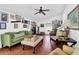 Bright living room features a ceiling fan, gallery wall, and tile flooring at 905 Simmons St, Mount Pleasant, SC 29464