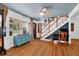 Cozy living room featuring hardwood floors, blue ceilings and a comfortable workspace near the staircase at 905 Simmons St, Mount Pleasant, SC 29464