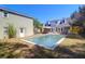 Backyard view showcasing a private in-ground pool, lush lawn, and two-story home at 905 Simmons St, Mount Pleasant, SC 29464