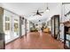 Expansive sunroom features tile floors, neutral paint, and double doors leading to the exterior at 905 Simmons St, Mount Pleasant, SC 29464