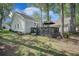 The backyard features a beautiful deck, green grass, and mature trees at 9146 Spring Branch Ct, North Charleston, SC 29406