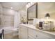 Well-lit bathroom features tiled shower/tub and modern vanity with decorative accents at 9146 Spring Branch Ct, North Charleston, SC 29406