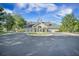 Community clubhouse boasts inviting facade with manicured lawn and ample parking at 9146 Spring Branch Ct, North Charleston, SC 29406