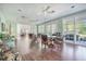 Spacious common room with wood floors, large windows, and comfortable seating at the Wellmore of Mount Pleasant, SC at 9146 Spring Branch Ct, North Charleston, SC 29406