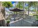 Comfortable deck with seating offers an outdoor living space in a wooded, natural setting at 9146 Spring Branch Ct, North Charleston, SC 29406