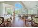 Bright dining room with large windows, hardwood floors, and elegant tables at the Wellmore of Mount Pleasant, SC at 9146 Spring Branch Ct, North Charleston, SC 29406