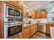Gourmet kitchen features stainless steel appliances, granite countertops, and custom wood cabinetry at 9146 Spring Branch Ct, North Charleston, SC 29406