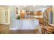 A spacious kitchen island complements stainless steel appliances and wood cabinetry at 9146 Spring Branch Ct, North Charleston, SC 29406