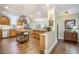 Open kitchen with wood cabinets, granite countertops, and an island that seamlessly connects to the living area at 9146 Spring Branch Ct, North Charleston, SC 29406