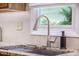 Granite countertop kitchen sink features a modern faucet and a view of the backyard at 9146 Spring Branch Ct, North Charleston, SC 29406