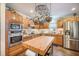 Well-equipped kitchen with stainless steel appliances, wooden cabinets, and an island offering ample counter space at 9146 Spring Branch Ct, North Charleston, SC 29406