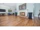 Comfortable living room with a brick fireplace, wood floors, and cozy seating at the Wellmore of Mount Pleasant, SC at 9146 Spring Branch Ct, North Charleston, SC 29406