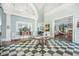 Elegant lobby with checkered floors, high ceilings, and beautiful decor at the Wellmore of Mount Pleasant, SC at 9146 Spring Branch Ct, North Charleston, SC 29406