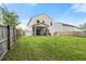 Grassy backyard showcasing a screened porch and wooden fence that offers a private outdoor space at 9660 Godwin St, Ladson, SC 29456