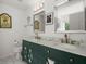 Elegant bathroom featuring double sinks, marble countertops and vintage style decor at 9660 Godwin St, Ladson, SC 29456