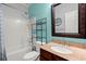 Well-lit bathroom featuring a vanity with granite top, white tiled shower and bathtub combo at 9660 Godwin St, Ladson, SC 29456
