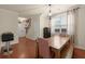 Bright dining area with hardwood floors, a chandelier, and an open view to the staircase at 9660 Godwin St, Ladson, SC 29456