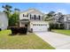 Welcoming two-story home with a spacious driveway, manicured lawn, and convenient two-car garage at 9660 Godwin St, Ladson, SC 29456