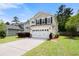 Inviting two-story home with a spacious driveway, well-kept lawn, and a convenient two-car garage at 9660 Godwin St, Ladson, SC 29456