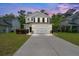 Charming two-story home with well-maintained lawn, a two-car garage and beautiful sunset lighting at 9660 Godwin St, Ladson, SC 29456
