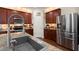 Modern kitchen featuring stainless steel appliances, granite countertops, and rich wood cabinetry at 9660 Godwin St, Ladson, SC 29456